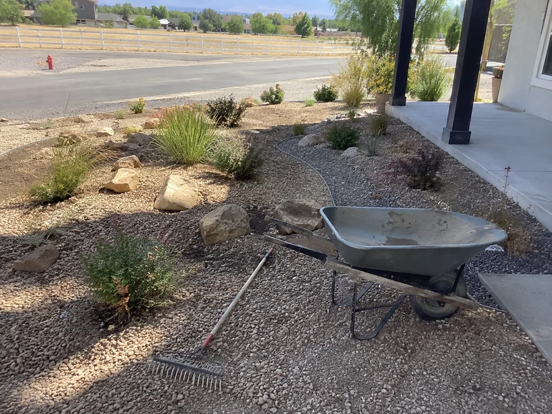Decorative gravel bed with steel edging and drought-tolerant plants in a water-wise Utah front yard