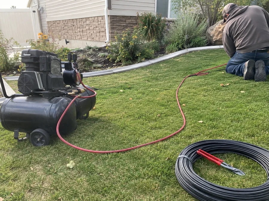Air compressor hooked up to a residential sprinkler system for a fall blowout