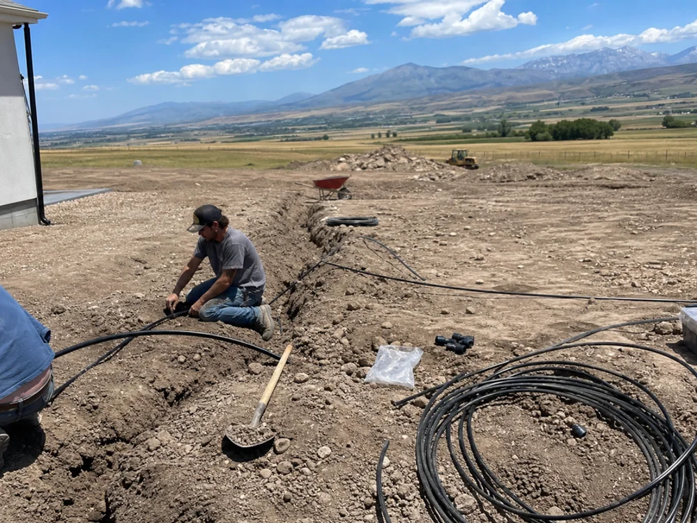 Irrigation lines being laid in a freshly graded new-construction yard