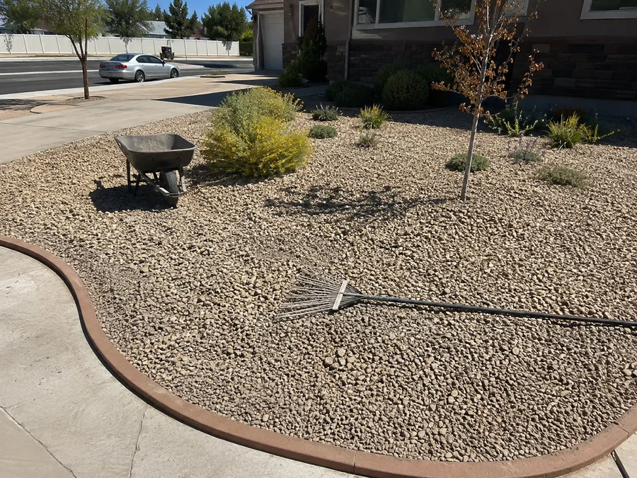 Finished low-water Utah front yard with gravel beds, drought-tolerant plants and crisp edging