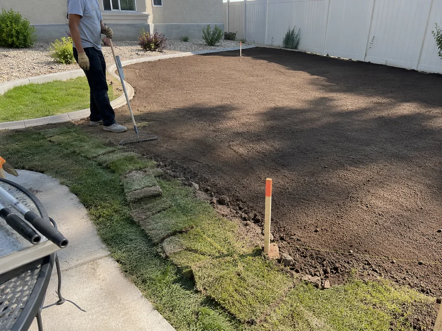 Freshly finish-graded topsoil raked smooth across a Utah yard ready for sod