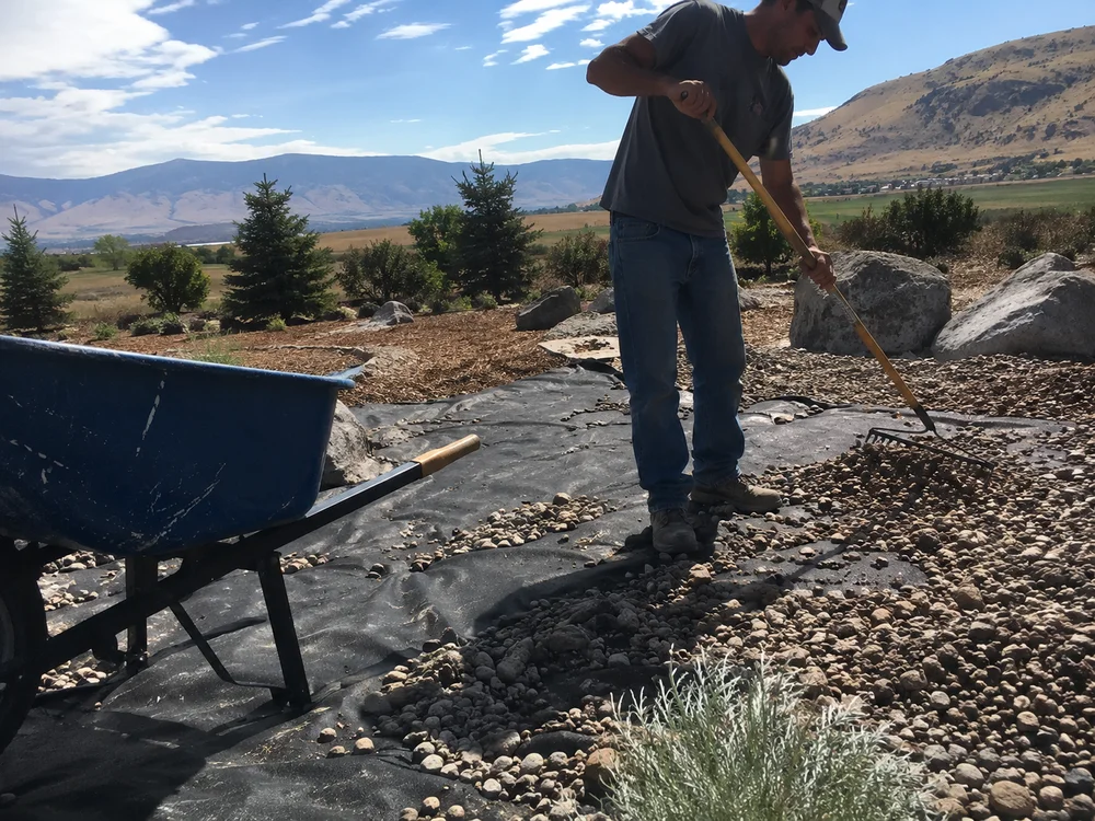 Geotextile weed fabric being covered with decorative gravel