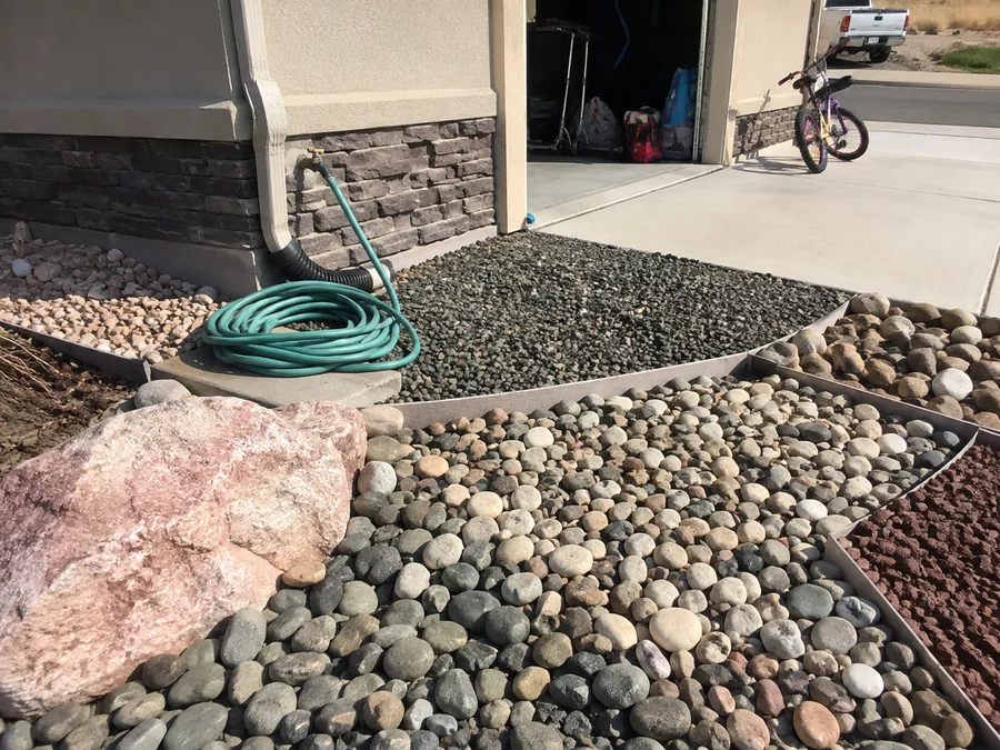 A range of decorative landscape rock colours and sizes laid in separate beds