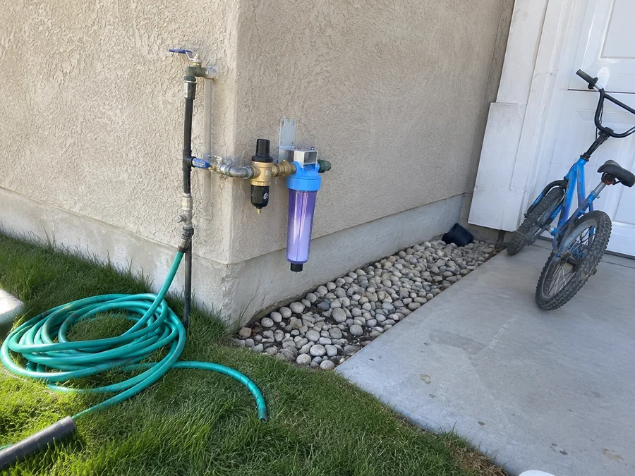 Secondary water connection with a filter canister and pressure reducer in a Utah side yard